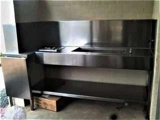 Stainless steel outdoor sink bench installed in a wall recess