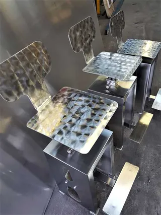 Polished stainless steel seats mounted on fabricated bases