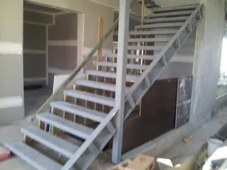 Painted steel staircase frame inside a building under construction